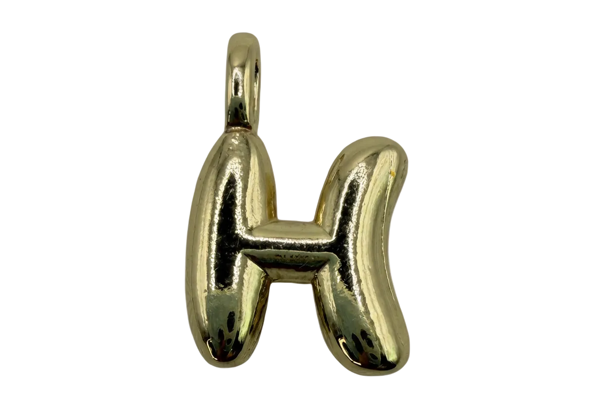 High-polish gold puffy letter H initial pendant on black background
