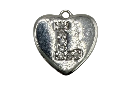 Silver heart with raised letter L accented by clear pavé stones on a textured background