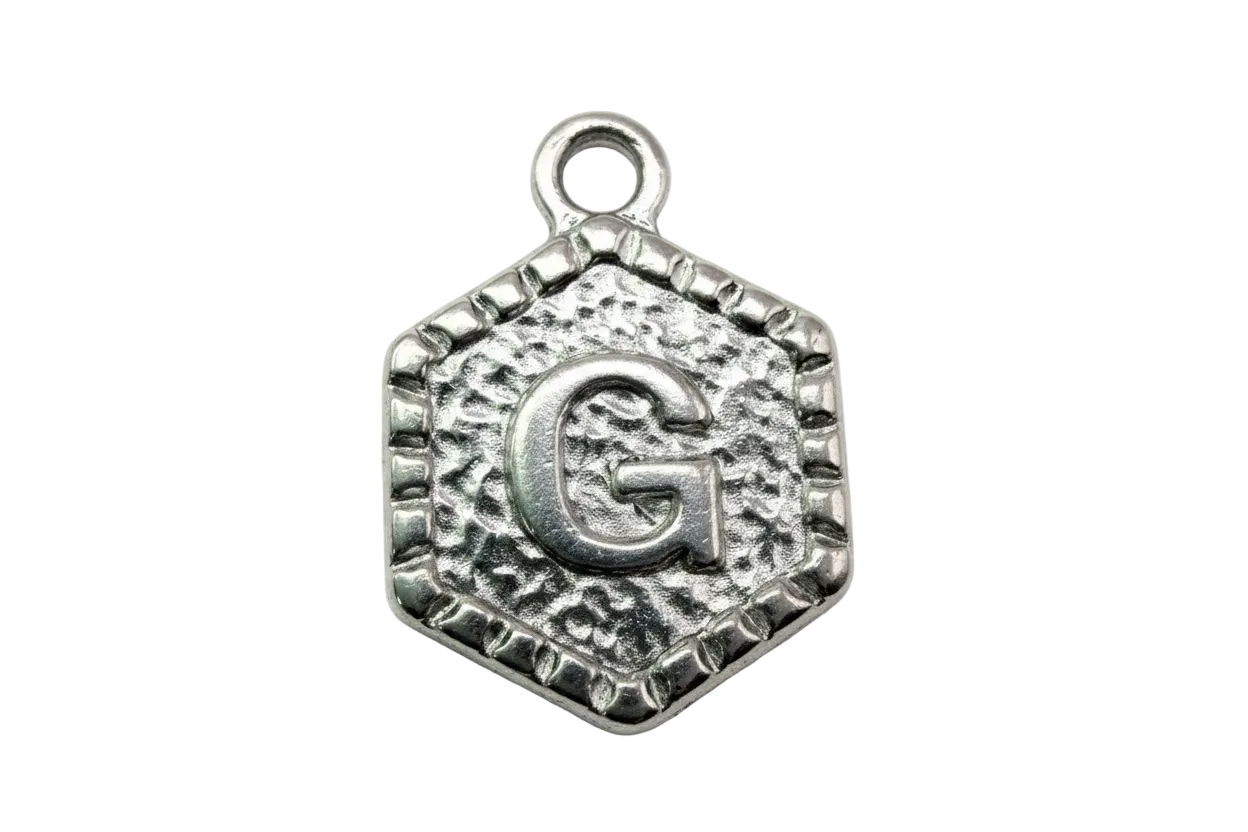 Antique silver hexagon letter G medallion with textured border