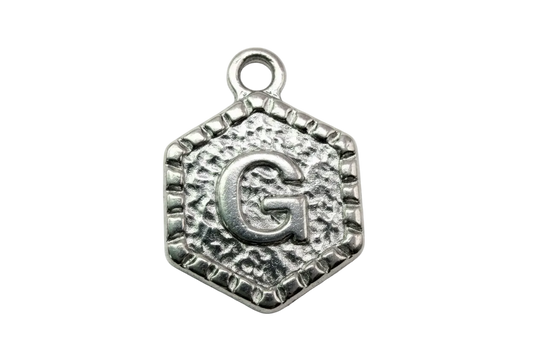 Antique silver hexagon letter G medallion with textured border