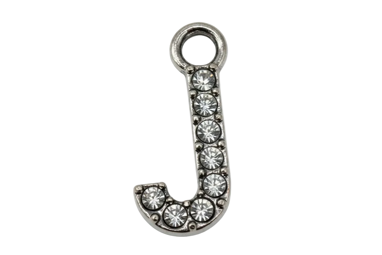 Silver letter J with pavé clear crystals, shown on black background