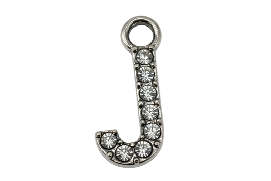 Silver letter J with pavé clear crystals, shown on black background