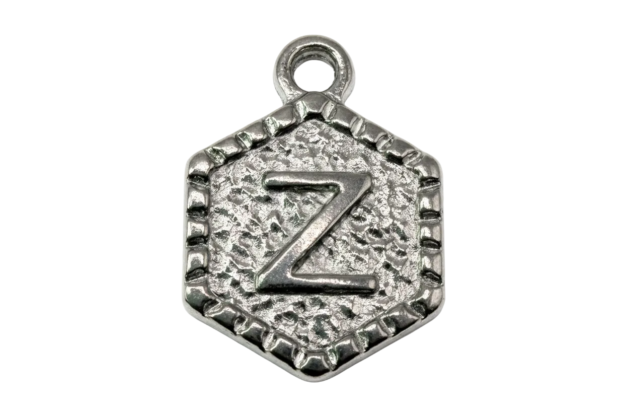 Antiqued silver hexagon medallion with raised letter Z and textured background