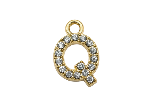 Gold letter Q initial with pavé clear crystals on a black background