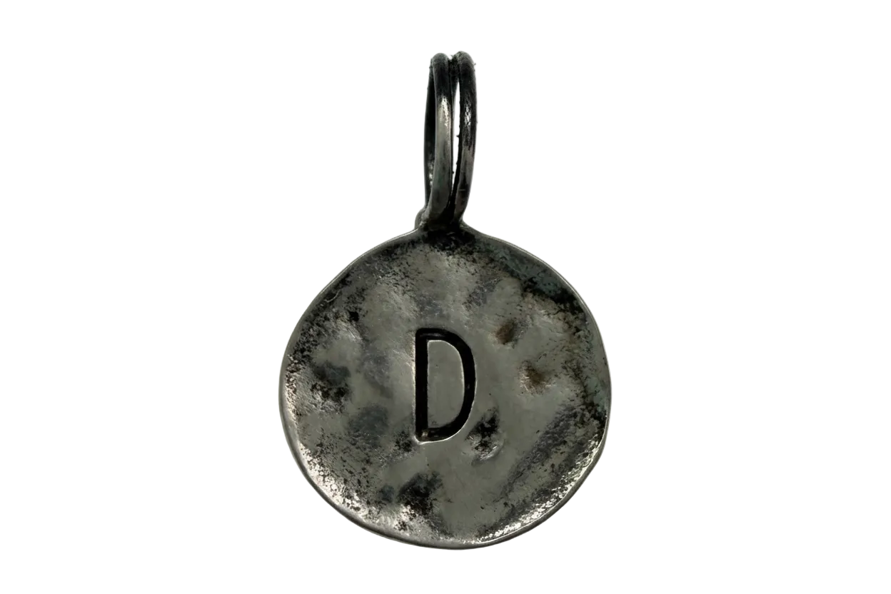 Antiqued silver round coin with stamped letter D
