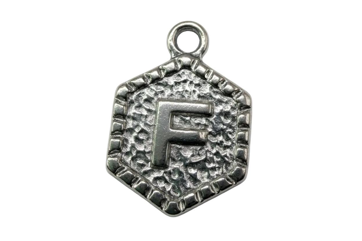 Antiqued silver-tone hexagon medallion with raised letter F and textured background