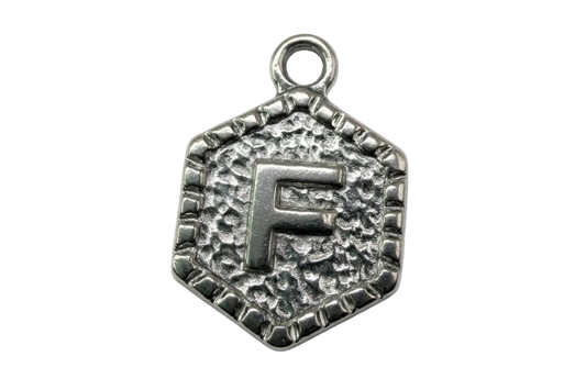 Antiqued silver-tone hexagon medallion with raised letter F and textured background