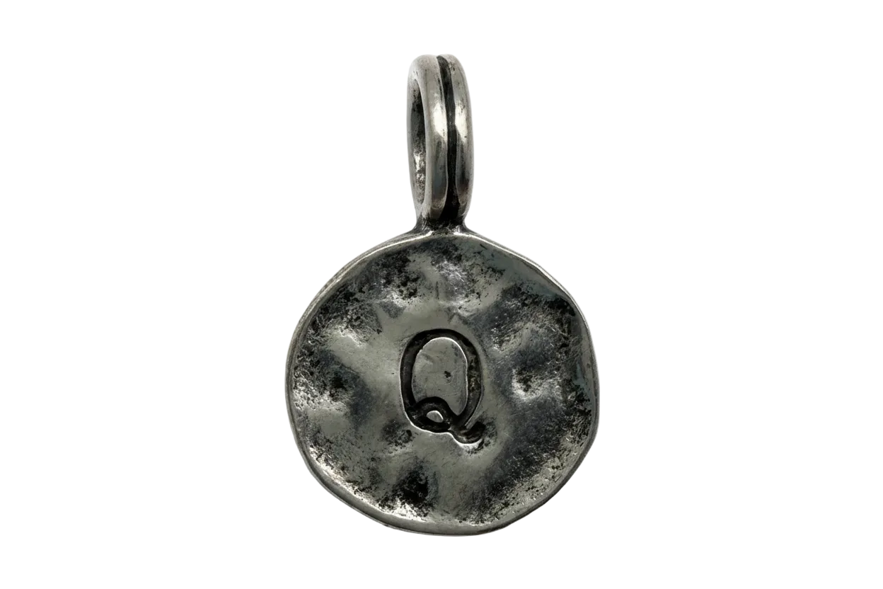 Oxidized silver coin charm with embossed letter Q