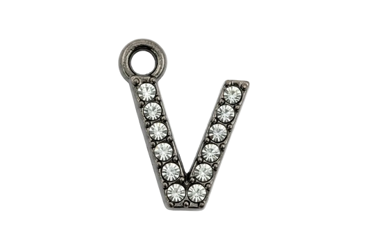 Silver letter V charm with clear crystal pavé detailing on a black background