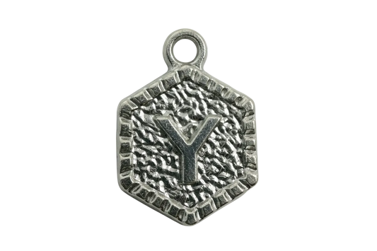 Silver hexagon medallion with raised letter Y and textured, oxidized finish