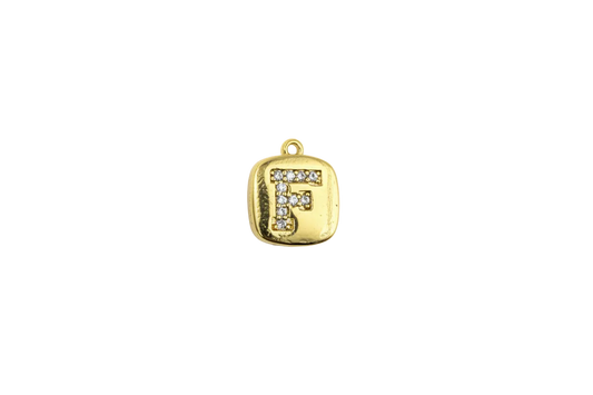Gold rounded-square tile with pavé letter F in clear stones