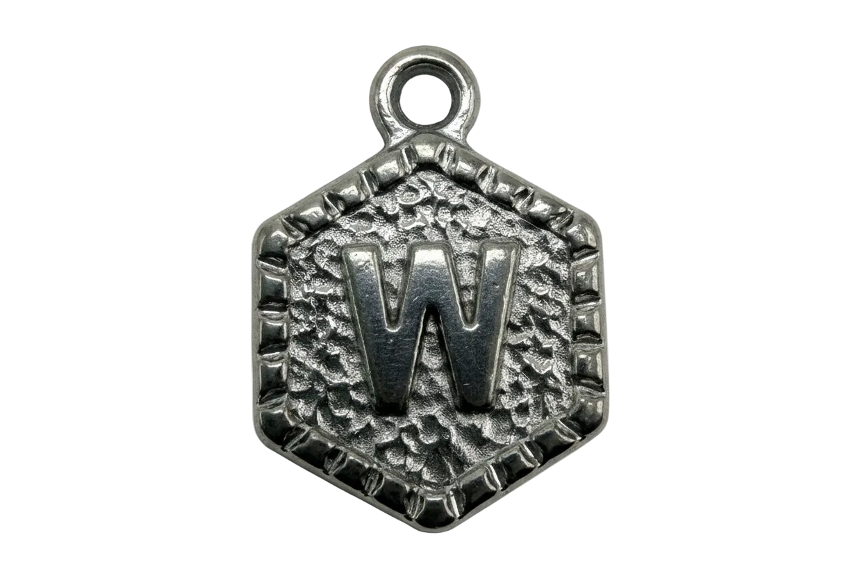 Oxidized silver hexagon tag with raised letter W and textured background