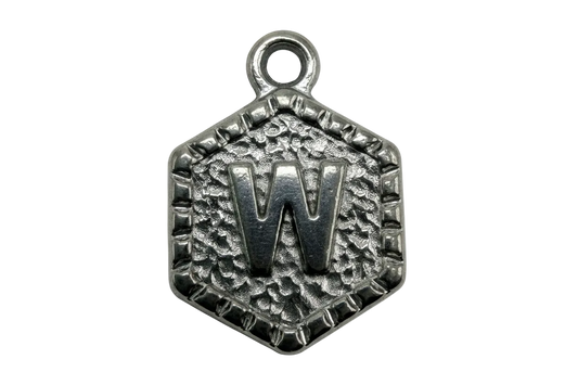 Oxidized silver hexagon tag with raised letter W and textured background