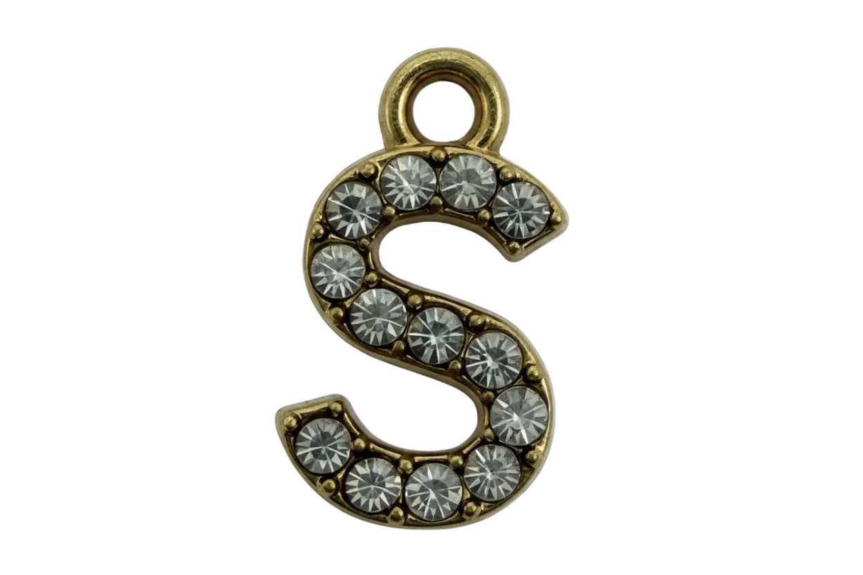 Gold letter S charm with clear pavé stones on a black background