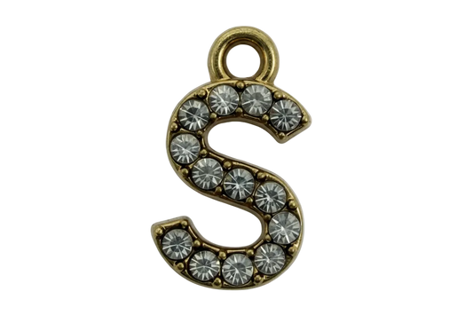 Gold letter S charm with clear pavé stones on a black background