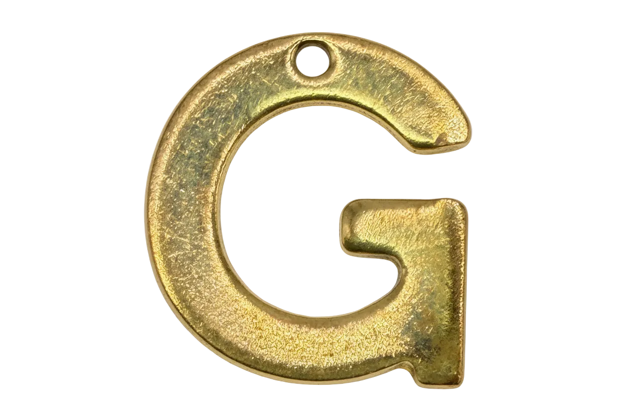 Textured gold letter G initial with a small clear gem accent