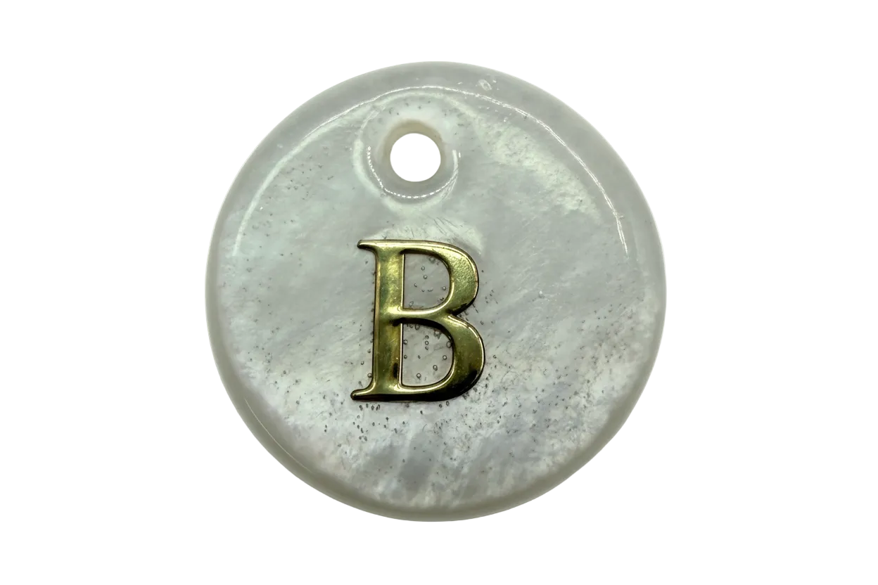 Glossy pearlescent white round disc with raised gold letter B