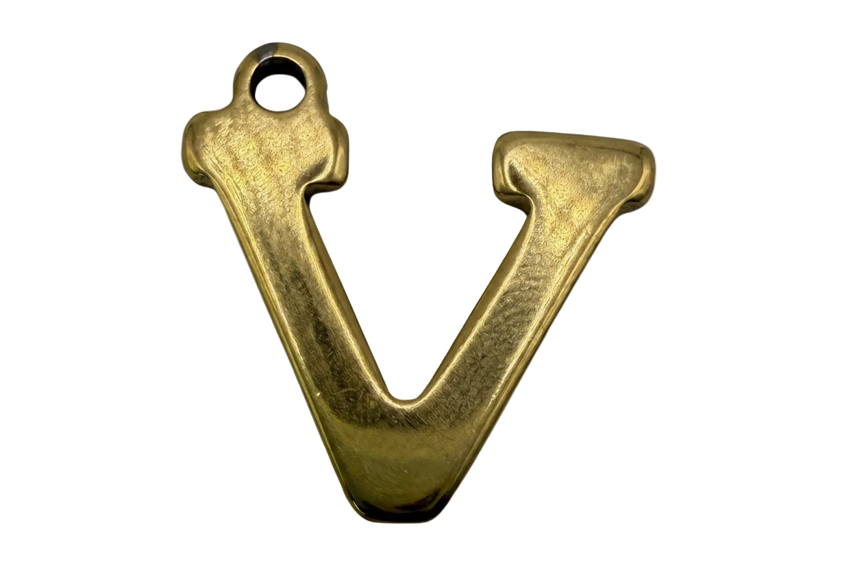 Sculpted gold letter V initial with a softly polished finish