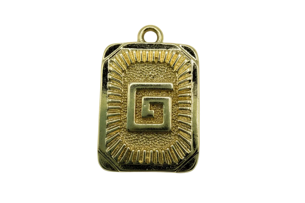 Gold rectangular medallion with raised Greek key center and sunburst ridges