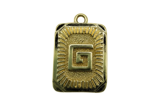 Gold rectangular medallion with raised Greek key center and sunburst ridges