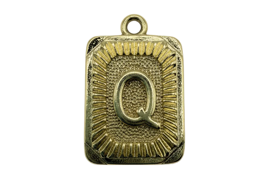 Gold rectangular initial plaque with raised letter Q and sunburst textured border