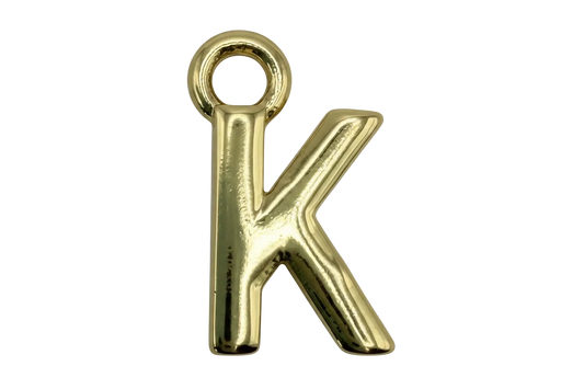 Polished gold letter K charm with a smooth reflective finish