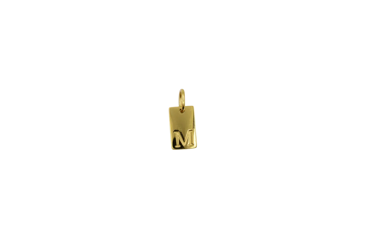 Gold rectangular tag with raised letter M