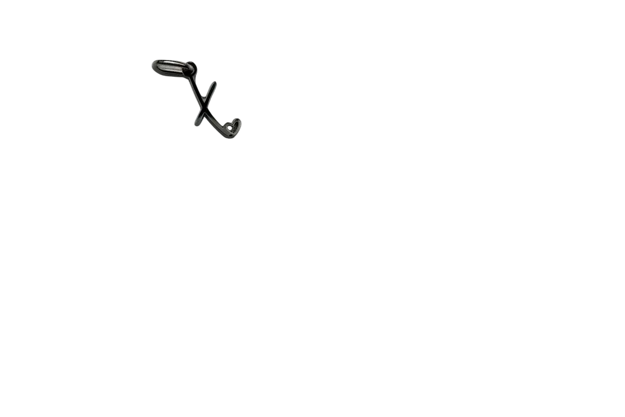 Silver-toned letter X with small heart detail, glossy finish