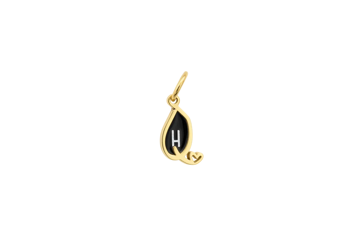 Gold teardrop pendant with black enamel and white H, heart detail