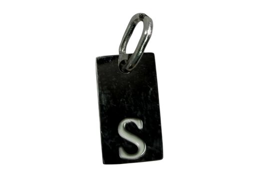 Rectangular black tag with raised silver letter S and polished silver-toned edge