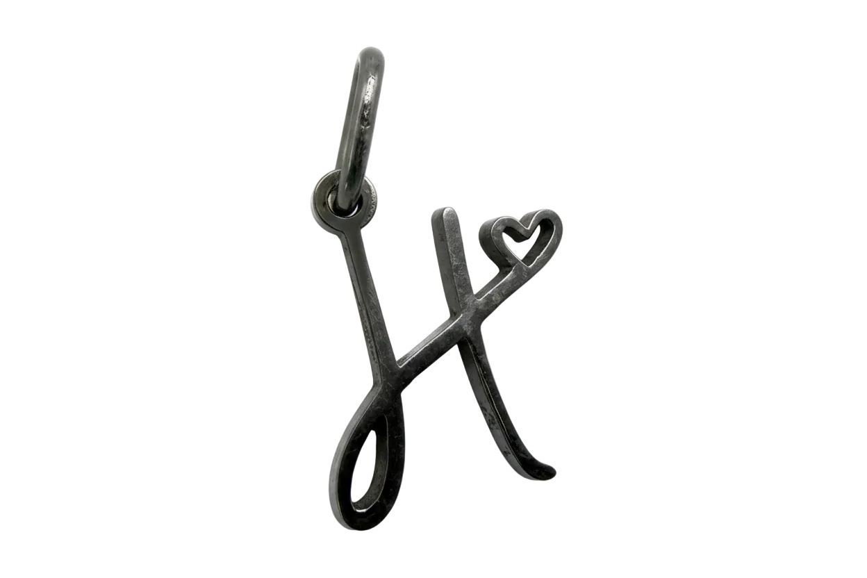 Dark silver-tone letter X initial with small heart detail, polished finish