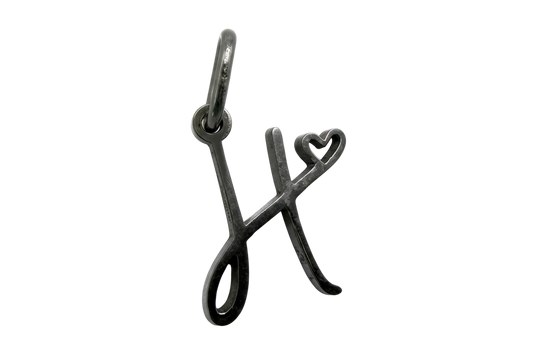 Dark silver-tone letter X initial with small heart detail, polished finish