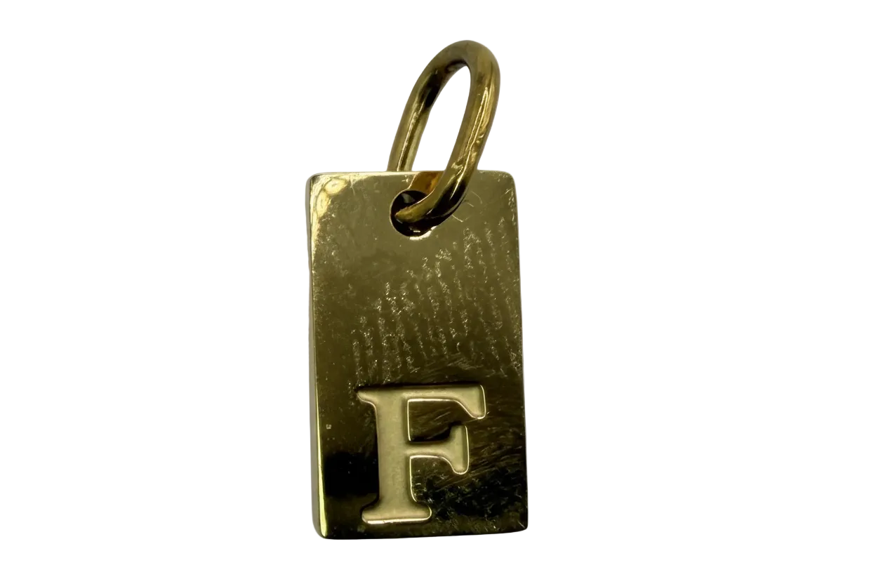 Polished gold rectangular initial tag with raised letter F