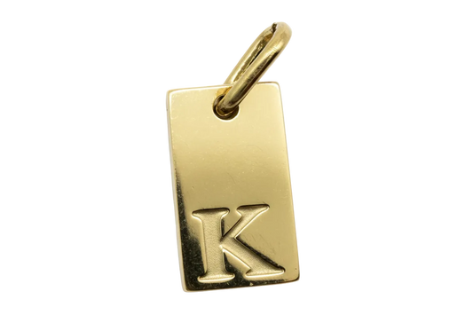 Polished gold rectangular tag with raised letter K initial