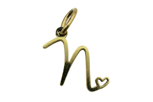 Polished gold script letter M with a small open heart detail