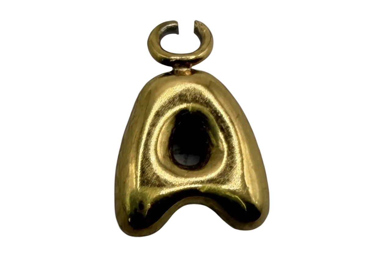 Polished gold sculptural mask charm with glossy black oval inlay