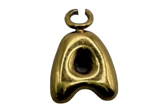 Polished gold sculptural mask charm with glossy black oval inlay