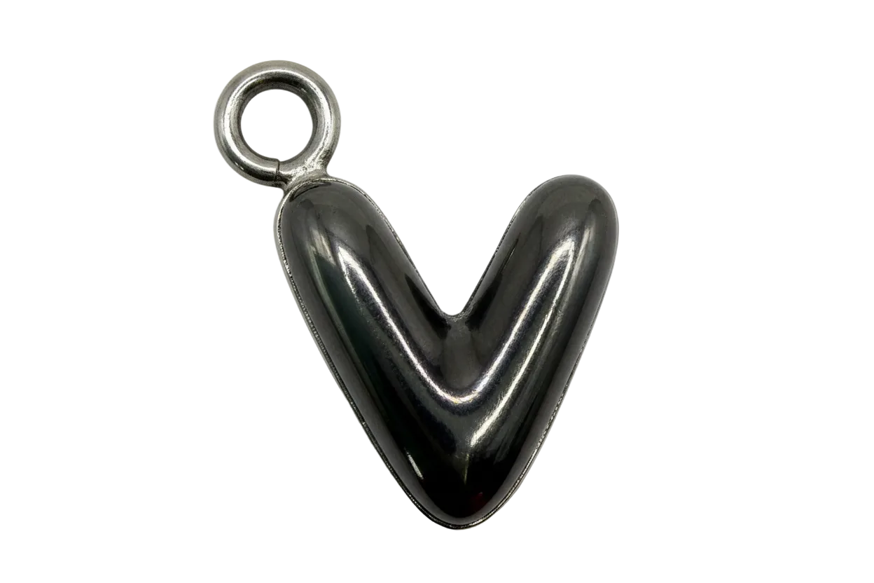 Mirror-polished puffed heart in silver with a small gold-toned accent