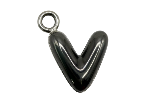 Mirror-polished puffed heart in silver with a small gold-toned accent