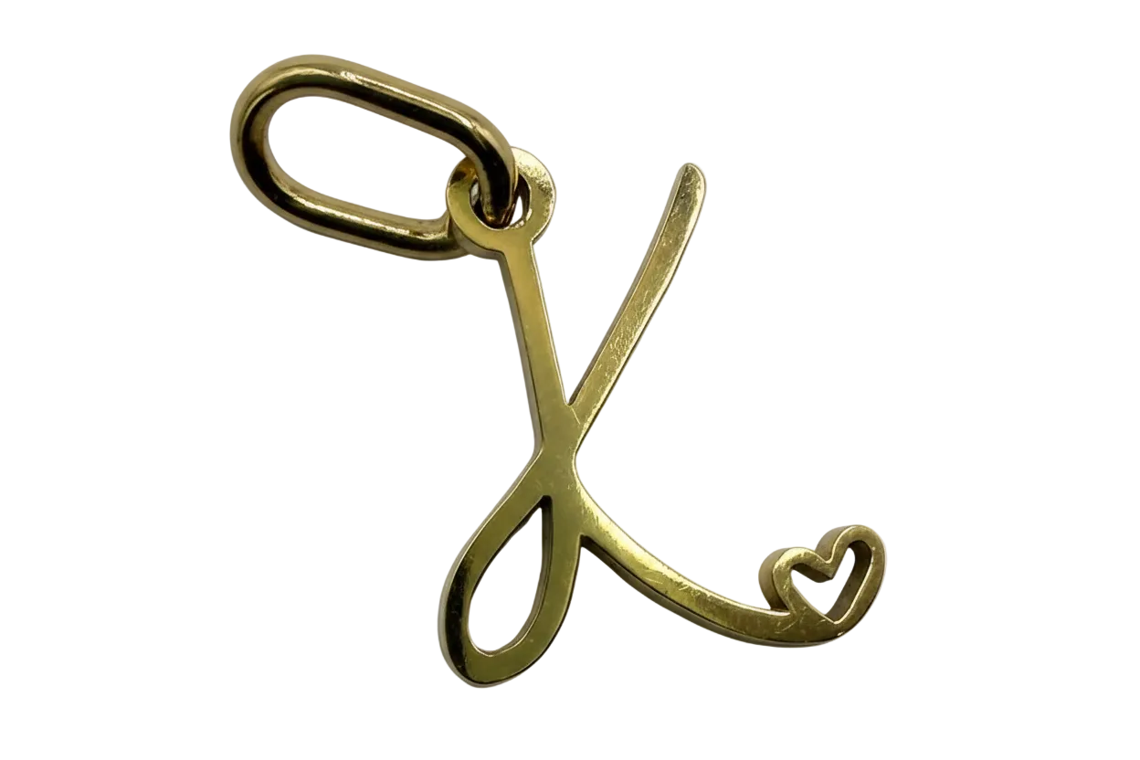 Gold script letter L initial with a small heart detail