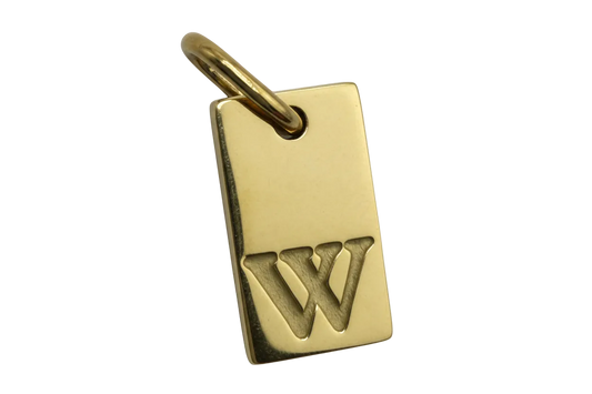 Gold rectangular tag charm with raised letter W