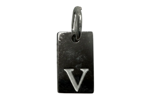 Polished silver rectangular tag with engraved letter V on black background