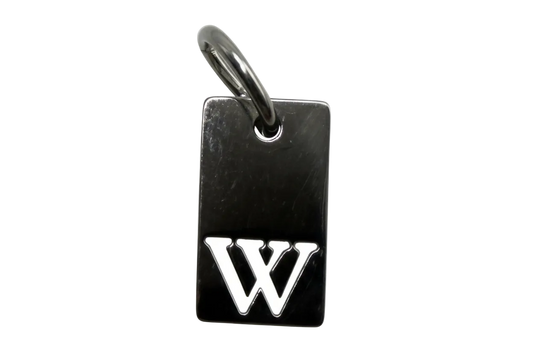 Glossy black rectangular tag charm with raised silver interlocking initials