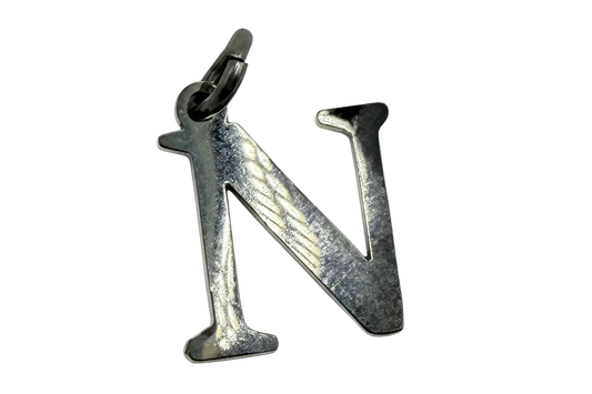Polished silver letter N initial charm with reflective finish