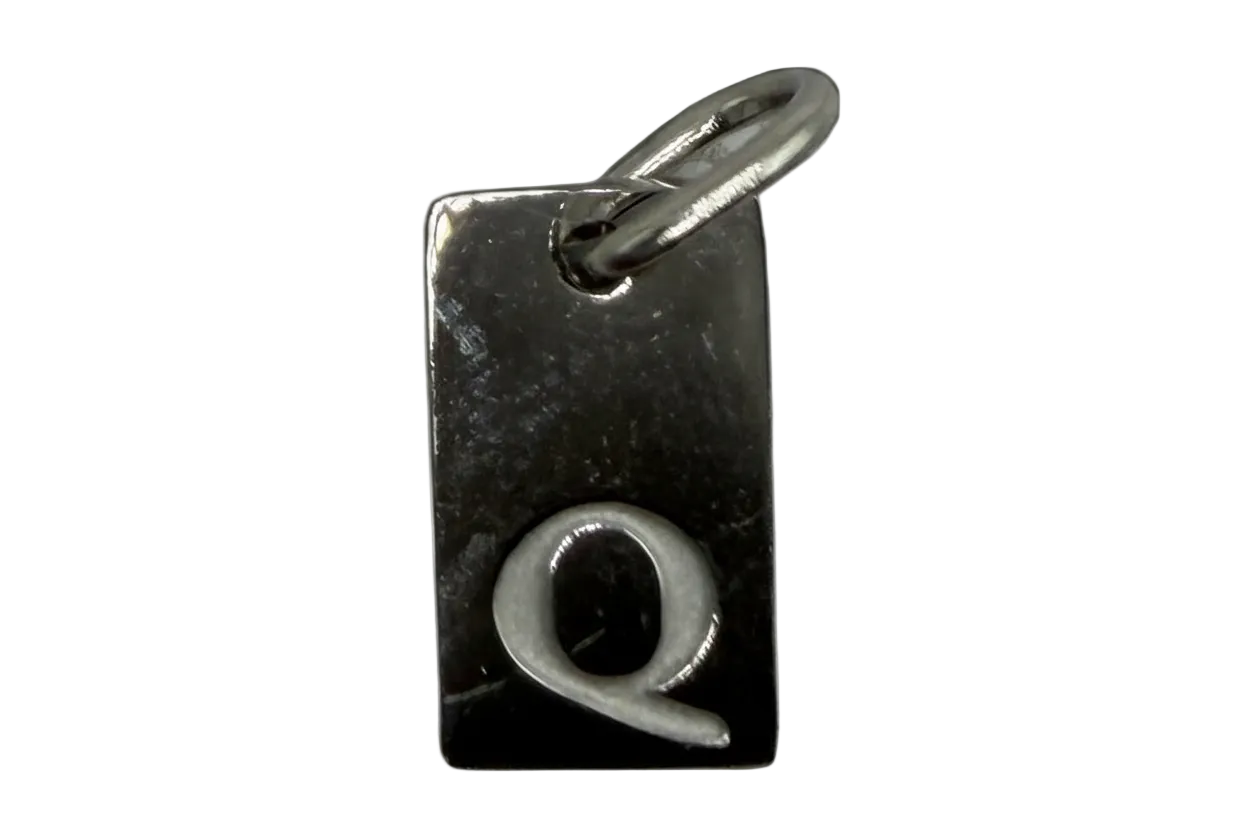 Glossy black rectangular initial Q tag with raised silver letter and polished finish