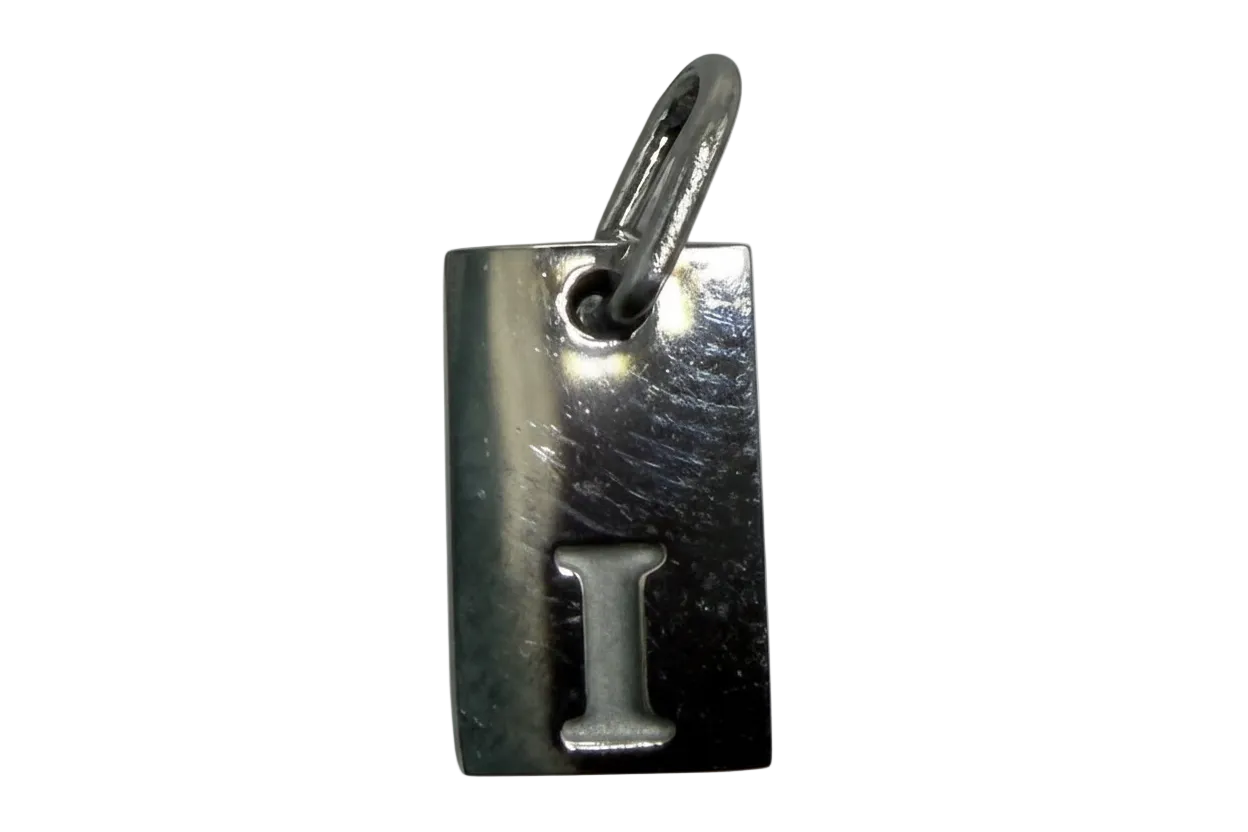 Polished silver-tone rectangular tag with raised letter I
