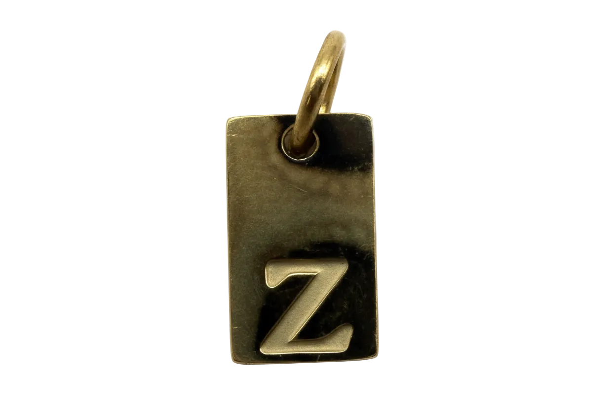 Antiqued gold rectangular tag with raised silver-tone letter Z