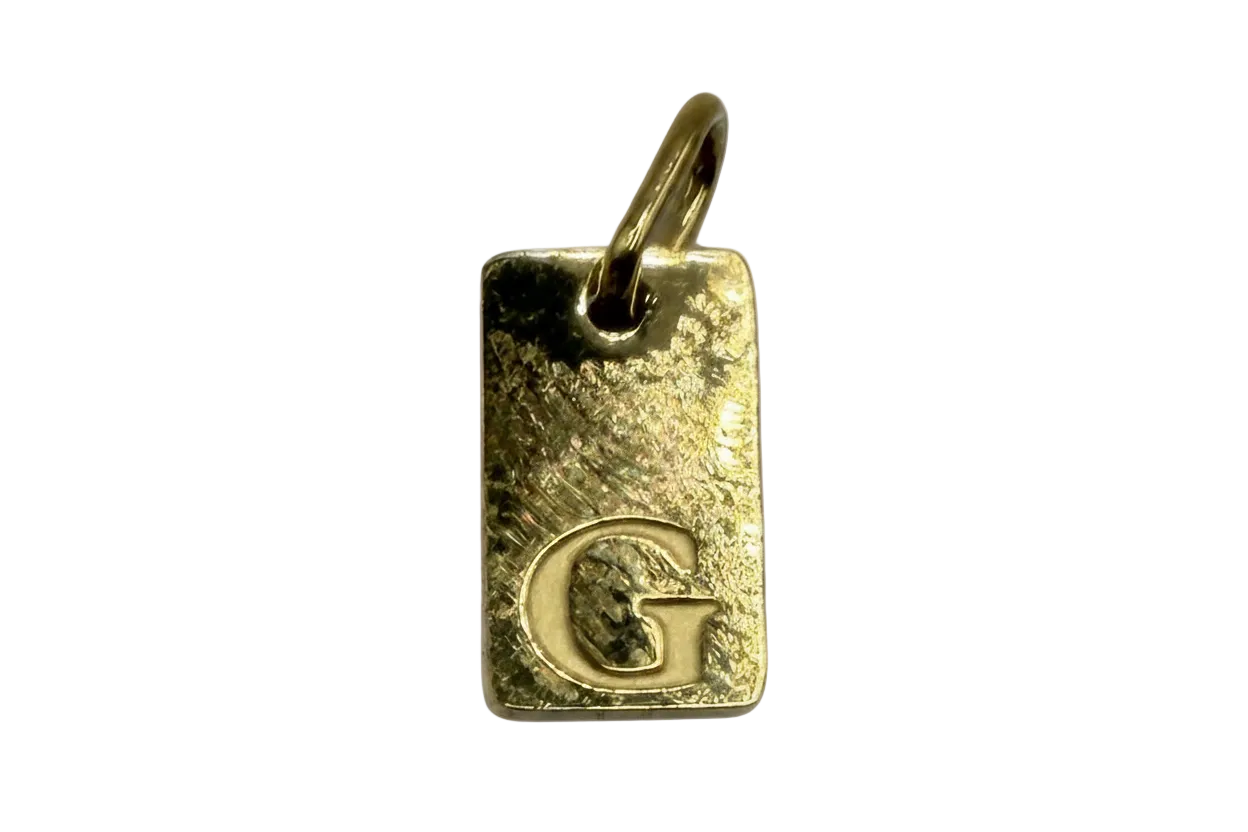 Gold hammered rectangular initial tag with raised letter G