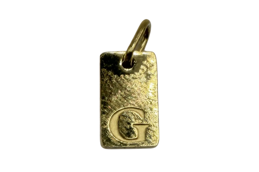 Gold hammered rectangular initial tag with raised letter G