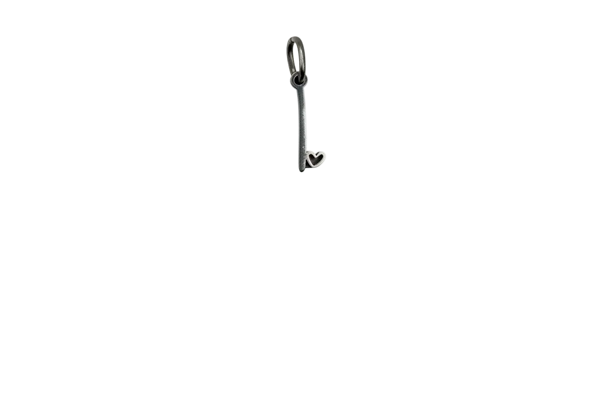 Polished silver key charm with small heart detail at the tip